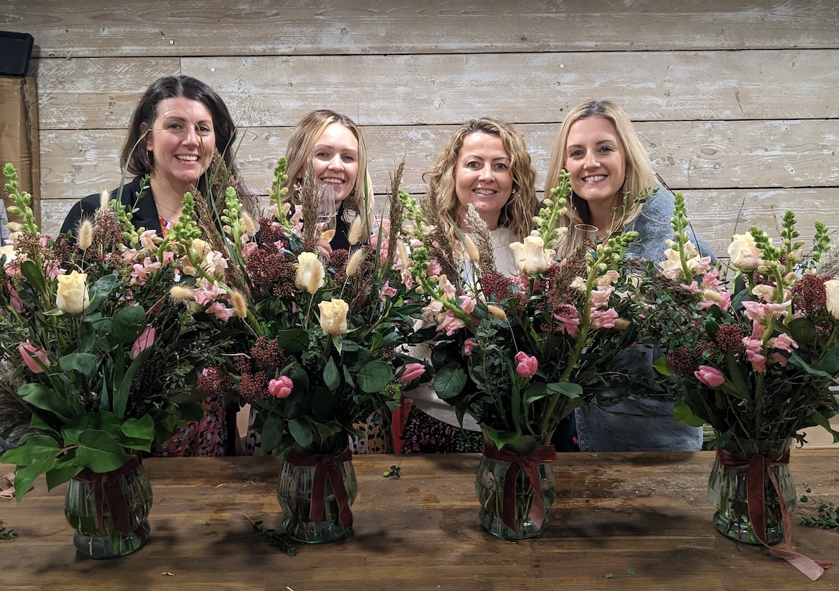 learners arrange flowers in a vase