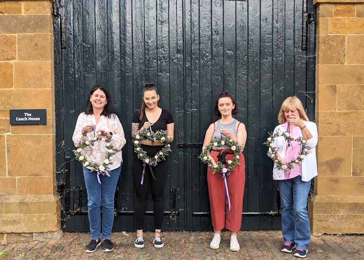 floristry for beginners participants holding wreaths